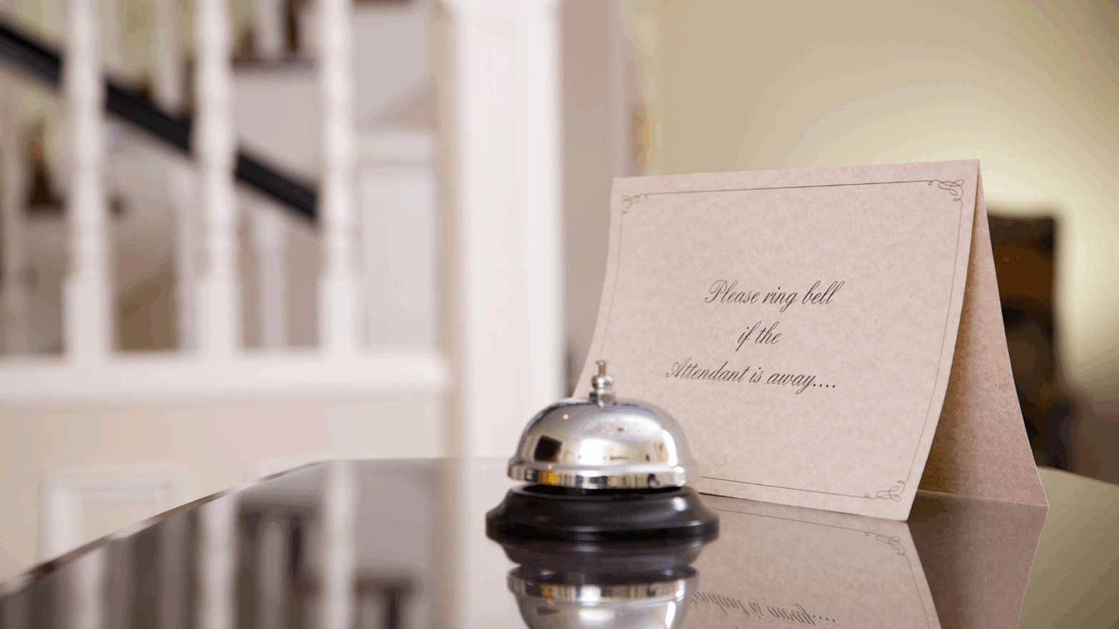 Hospitality front desk with bell and sign