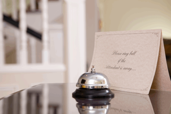 Hospitality front desk with bell and sign